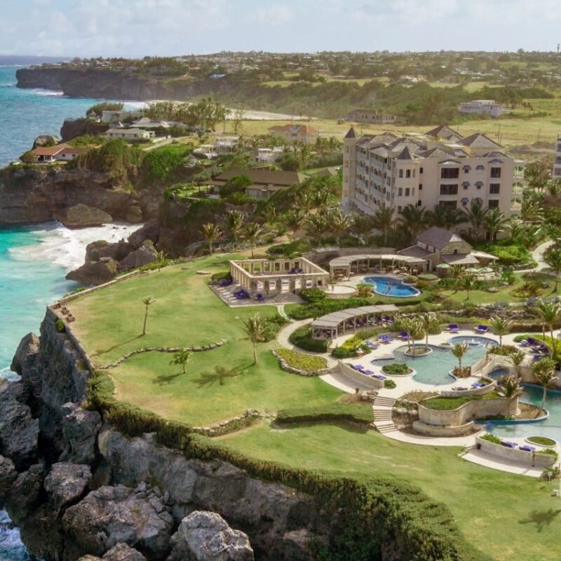 Aerial view of luxury oceanfront resorts in Barbados, a Caribbean destination offering new travel experiences in 2025.