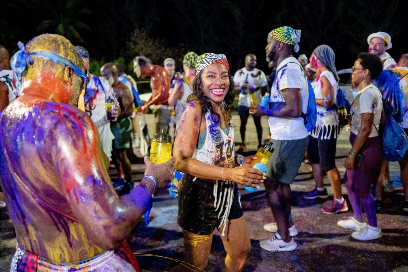 Tourists and locals celebrating Foreday Morning in Barbados, a festival filled with music, colors, and Caribbean culture.