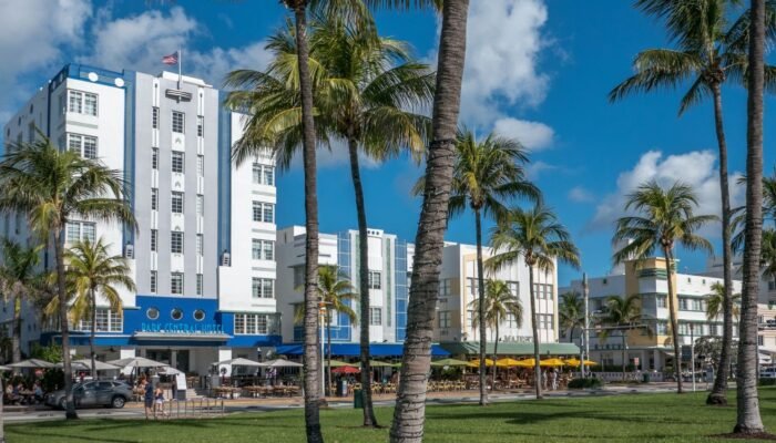 Fachadas Art Déco en Ocean Drive, Miami Beach, con palmeras y hoteles emblemáticos como parte del distrito histórico.