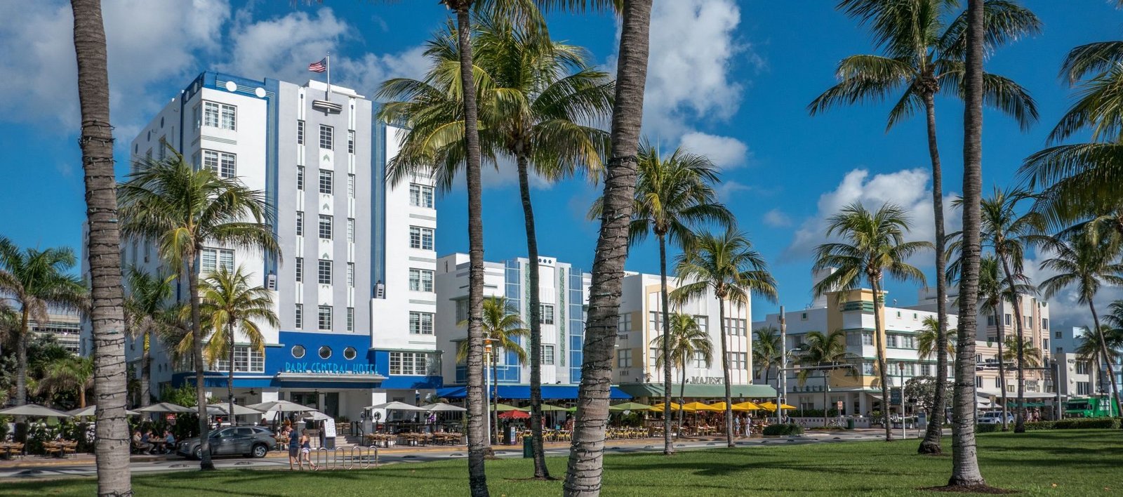 Fachadas Art Déco en Ocean Drive, Miami Beach, con palmeras y hoteles emblemáticos como parte del distrito histórico.