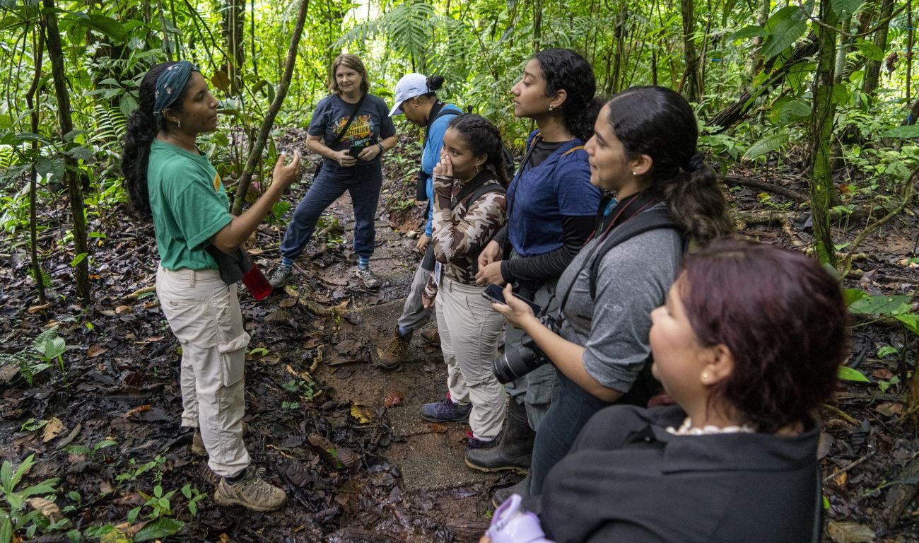 Guía del Smithsonian Tropical Research Institute explica la historia de Barro Colorado a un grupo de visitantes en la selva tropical de Panamá.