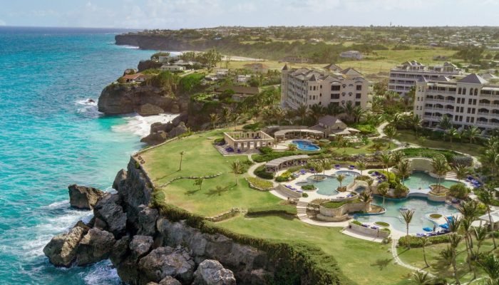Vista aérea de resorts de lujo frente al mar en Barbados, un destino caribeño con nuevas experiencias turísticas en 2025.