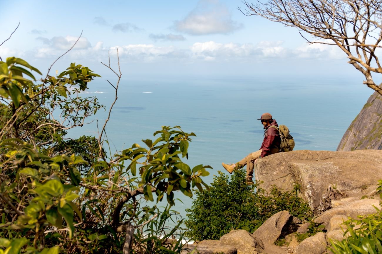 Hiker taking in the panoramic view from Pedra Bonita, one of the most impressive viewpoints in Rio de Janeiro, Brazil.